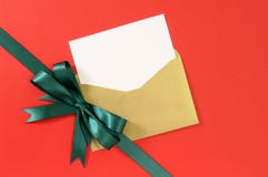 Christmas Card, Red Gift Paper Background, Green Ribbon Bow Diagonal, White Copy Space Royalty Free Stock Photo