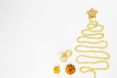 Christmas tree made of gold bead garland with decorations on white background. stock photos Christmas tree made of gold bead garland with decorations on white background. stock photos