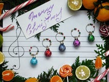 Christmas composition. Christmas decoration balls are arranged on the paper like music notes stock photos Christmas composition. Christmas decoration balls are arranged on the paper like music notes stock photos