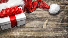 Christmas decoration. Gift box red ribbon bow falling snow stock photography Christmas decoration. Gift box red ribbon bow falling snow stock photography