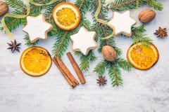 Christmas decoration over white wood background. Top view of homemade butter nuts star shaped cookies with icing, pine, orange royalty free stock photos Christmas decoration over white wood background. Top view of homemade butter nuts star shaped cookies with icing, pine, orange royalty free stock photos