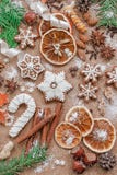Christmas decoration with spices and cookies in the shape of snowflakes on dark brown paper background. Top view. stock image Christmas decoration with spices and cookies in the shape of snowflakes on dark brown paper background. Top view. stock image