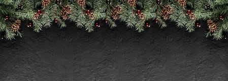 Christmas Fir branches with pine cones on dark black background. Xmas and Happy New Year card, bokeh, sparking, glowing. stock images Christmas Fir branches with pine cones on dark black background. Xmas and Happy New Year card, bokeh, sparking, glowing. stock images