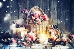 Christmas Gifts In Basket And Burning Candle. Vintage Style Stock Image Christmas Gifts In Basket And Burning Candle. Vintage Style Stock Image