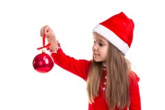 Christmas girl holding and looking at a christmas tree toy in the hand, wearing a santa hat isolated over a white royalty free stock images Christmas girl holding and looking at a christmas tree toy in the hand, wearing a santa hat isolated over a white royalty free stock images