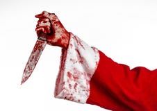 Christmas and Halloween theme: Santa's bloody hands of a madman holding a bloody knife on an isolated white background royalty free stock photos Christmas and Halloween theme: Santa's bloody hands of a madman holding a bloody knife on an isolated white background royalty free stock photos