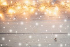 Christmas light and christmas decoration with snow on white wood stock photo Christmas light and christmas decoration with snow on white wood stock photo
