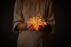 Christmas lights garland in female hands stock photo Christmas lights garland in female hands stock photo