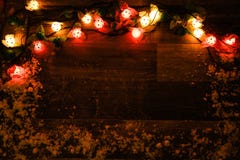 Christmas Lights On Dark Wooden Board Stock Image