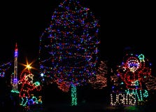 Christmas Lights - Santa And Elf Decorating Tree Stock Image