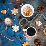 Christmas or New year breakfast. Gingerbread, candy cane and coffee cup on dark background. Flat lay. Top view Stock Photography Christmas or New year breakfast. Gingerbread, candy cane and coffee cup on dark background. Flat lay. Top view Stock Photography