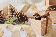 Christmas and New Year holidays concept. Gift boxes with ribbon, fir branch, cones on white knitted background stock photo Christmas and New Year holidays concept. Gift boxes with ribbon, fir branch, cones on white knitted background stock photo