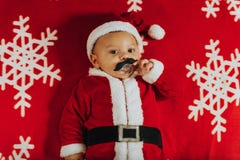 Christmas portrait of adorable newborn baby wearing Santa Claus` outfit royalty free stock photos Christmas portrait of adorable newborn baby wearing Santa Claus` outfit royalty free stock photos