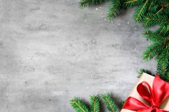Christmas Presents With Red Ribbon On Gray Background In A Frame Made Of Fir Branches. Flat Lay, Top View. Christmas Background Royalty Free Stock Photography Christmas Presents With Red Ribbon On Gray Background In A Frame Made Of Fir Branches. Flat Lay, Top View. Christmas Background Royalty Free Stock Photography