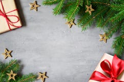 Christmas Presents With Red Ribbon On Gray Background In A Frame Made Of Fir Branches With Star. Flat Lay, Top View. Christmas Royalty Free Stock Image Christmas Presents With Red Ribbon On Gray Background In A Frame Made Of Fir Branches With Star. Flat Lay, Top View. Christmas Royalty Free Stock Image