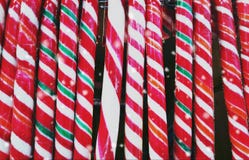 Christmas red and white candy canes closeup in a street market- vintage retro effect. Christmas treats concept stock photo Christmas red and white candy canes closeup in a street market- vintage retro effect. Christmas treats concept stock photo