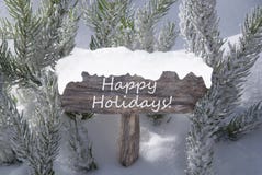 Christmas Sign Snow Fir Tree Branch Text Happy Holidays stock photo Christmas Sign Snow Fir Tree Branch Text Happy Holidays stock photo