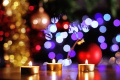 Christmas spirit scene with golden candles and glittering tree and baubles Royalty Free Stock Photo Christmas spirit scene with golden candles and glittering tree and baubles Royalty Free Stock Photo