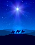 Christmas star on blue sky and three wise men
