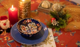 Christmas table with dishes, candles and figure of santa claus stock image Christmas table with dishes, candles and figure of santa claus stock image