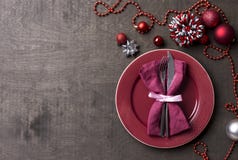 Christmas table setting with red festive decor and fork and knife on wood table. Top view. Xmas Party royalty free stock image Christmas table setting with red festive decor and fork and knife on wood table. Top view. Xmas Party royalty free stock image