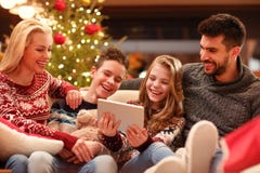 Christmas time- family watching funny video on digital tablet Stock Photos Christmas time- family watching funny video on digital tablet Stock Photos