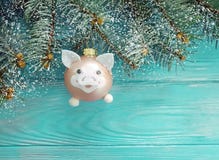 Christmas toy pig card on a wooden background, snow, tree branch stock photo Christmas toy pig card on a wooden background, snow, tree branch stock photo