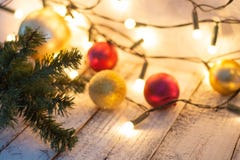 Christmas tree branch, lights and baubles on white wooden table with copy space. stock photography Christmas tree branch, lights and baubles on white wooden table with copy space. stock photography