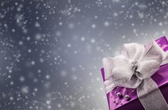 Christmas or Valentine's purple gift with silver ribbon abstract gray background stock image Christmas or Valentine's purple gift with silver ribbon abstract gray background stock image