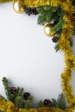 Christmas vertical greeting card with copy space. Ornament decorations such as gold baubles, tinsel, evergreen tree branches and royalty free stock photos Christmas vertical greeting card with copy space. Ornament decorations such as gold baubles, tinsel, evergreen tree branches and royalty free stock photos