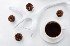 Christmas and winter concept. White mug of hot black coffee and cones, horns on white background. Top view. stock photos Christmas and winter concept. White mug of hot black coffee and cones, horns on white background. Top view. stock photos