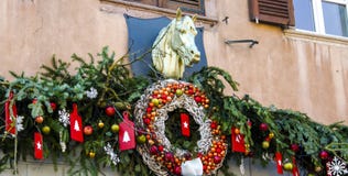 Christmas wreath and decorations on facade with sculpture of horse. royalty free stock image Christmas wreath and decorations on facade with sculpture of horse. royalty free stock image
