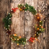 Christmas wreath of Fir branches, cones, red decoration on wooden background with snowflakes. royalty free stock photos Christmas wreath of Fir branches, cones, red decoration on wooden background with snowflakes. royalty free stock photos