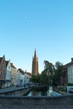 Church Of Our Lady and beautiful narrow street with canal in Bruges, Belgium stock photos Church Of Our Lady and beautiful narrow street with canal in Bruges, Belgium stock photos