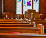Church Pews With Stained Glass Stock Photo