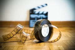 Cinema film reel and out of focus movie clapper board stock photos Cinema film reel and out of focus movie clapper board stock photos