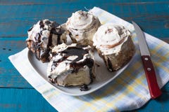 Cinnabon - Käse und Schokolade, auf einer Platte, über Serviette mit Sahne Zimtgebäck lizenzfreie stockfotos Cinnabon - Käse und Schokolade, auf einer Platte, über Serviette mit Sahne Zimtgebäck lizenzfreie stockfotos
