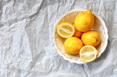 Citrons frais dans un plat de porcelaine de cru, côté droit, sur un fond blanc image stock Citrons frais dans un plat de porcelaine de cru, côté droit, sur un fond blanc image stock