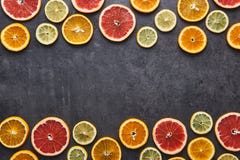 Citrus fruits pattern of lemon, orange and grapefruit on black stone background. stock image Citrus fruits pattern of lemon, orange and grapefruit on black stone background. stock image