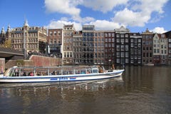 City view of canals, dutch houses and tour boat, Amsterdam, Netherlands. stock image City view of canals, dutch houses and tour boat, Amsterdam, Netherlands. stock image