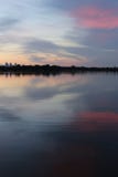 Cityscape and lake collide with the colors of the setting sun royalty free stock photo Cityscape and lake collide with the colors of the setting sun royalty free stock photo