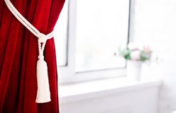 The claret curtain collected by a decorative lace near a window royalty free stock image The claret curtain collected by a decorative lace near a window royalty free stock image