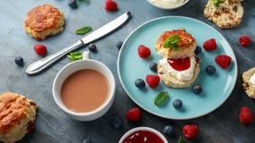 Classic scones with clotted cream, strawberries jam, english Tea and other fruit royalty free stock photos Classic scones with clotted cream, strawberries jam, english Tea and other fruit royalty free stock photos