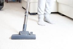Cleaning the carpet with vacuum cleaner in the living room stock image Cleaning the carpet with vacuum cleaner in the living room stock image