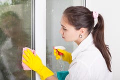 Cleaning concept. Young woman washing window stock image Cleaning concept. Young woman washing window stock image