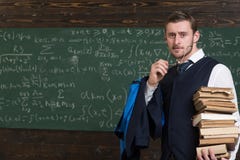 Clear explanation. Teacher formal wear and glasses looks smart, chalkboard background. Chalkboard full of math formulas stock photo Clear explanation. Teacher formal wear and glasses looks smart, chalkboard background. Chalkboard full of math formulas stock photo