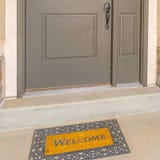 Clear Square Gray front door of a home with a simple green wreath and sidelight royalty free stock photography Clear Square Gray front door of a home with a simple green wreath and sidelight royalty free stock photography