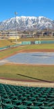 Clear Vertical Baseball field with green tiered seating against mountain and vibrant blue sky royalty free stock photos Clear Vertical Baseball field with green tiered seating against mountain and vibrant blue sky royalty free stock photos