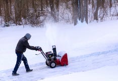Clearing snow from a drivway using snowblower royalty free stock photos Clearing snow from a drivway using snowblower royalty free stock photos