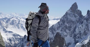 Climber mountaineer man reaching snowy mount top with ice axe in sunny day.Mountaineering ski activity. Skier people stock footage Climber mountaineer man reaching snowy mount top with ice axe in sunny day.Mountaineering ski activity. Skier people stock footage